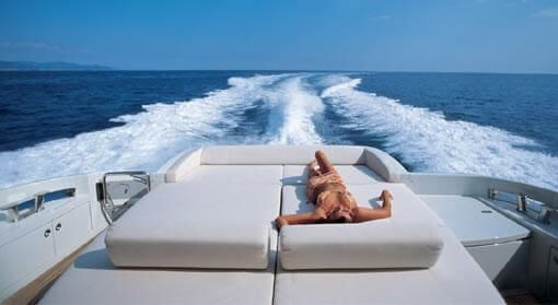 beautiful woman sunbathing on Azimut Yacht