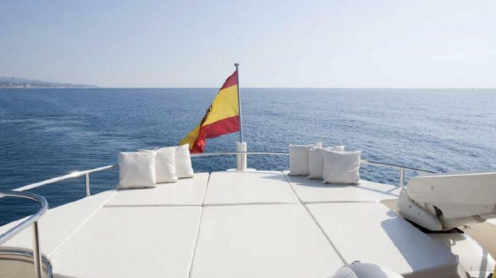 Spanish flag in wind on yacht rear