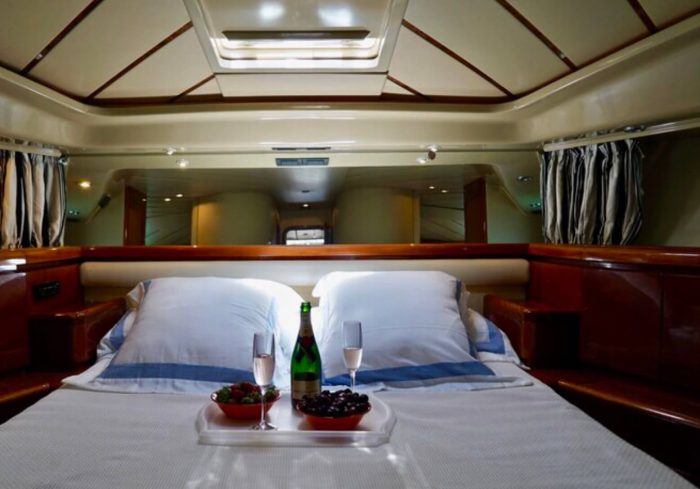 1996 Ferretti Yachts bedroom with a tray of champagne and fruit