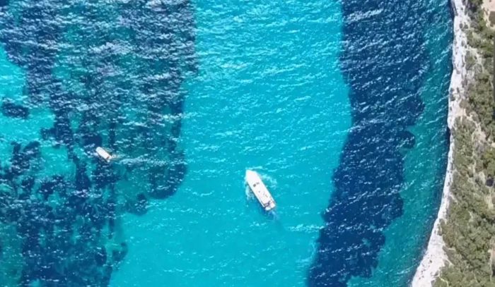 distant arial shot of 1996 Ferretti Yacht in beautiful waters